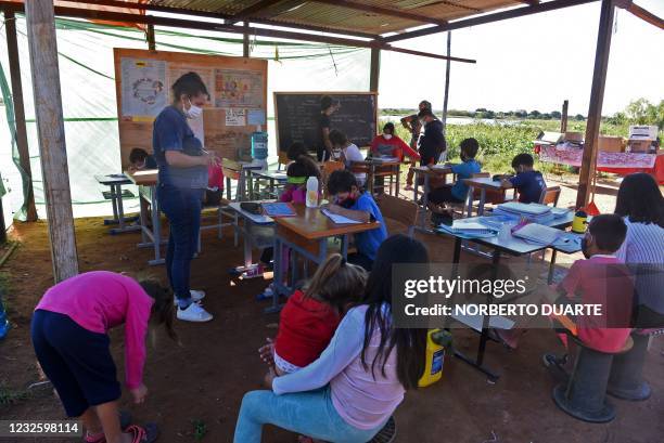 Children attend a class at an open-air space in Asuncion, on April 29 amid the COVID-19 pandemic. - Since public schools are closed due to the...