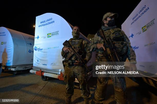Soldiers guard a container with 1 000 doses of the Pfizer-BioNTech vaccine against COVID-19 upon its arrival at the Viracopos International Airport...