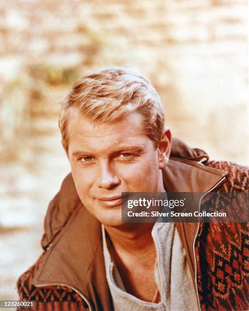 Troy Donahue , US actor, wearing a grey sweatshirt beneath a brown zip-up jacket with a patterned fabric exterior, circa 1955.