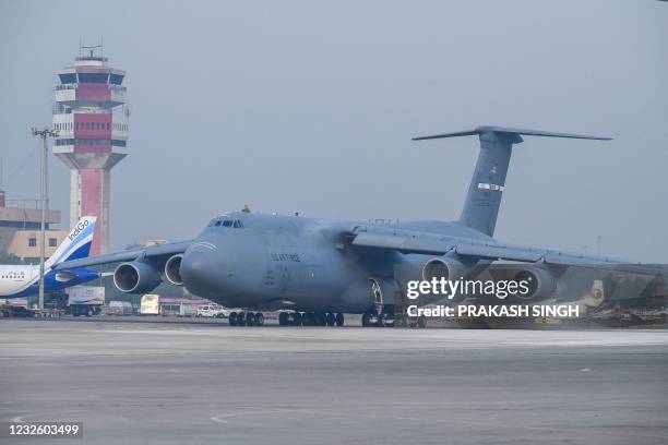 An US Air Force aircraft is seen on the tarmac after landing with Covid-19 coronavirus relief supplies from the US at the Indira Gandhi International...