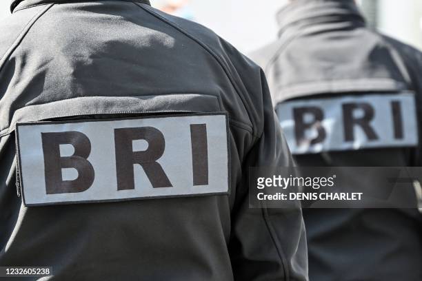 Members of the research and intervention brigade unit BRI, stand guard as they attend a remembrance gathering for murdered Stephanie Monferme, a...