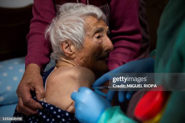 Eulogia Lage receives a dose of the Janssen vaccine against COVID-19 at her home in Taboadela during an in-house vaccination campaign for the elderly...