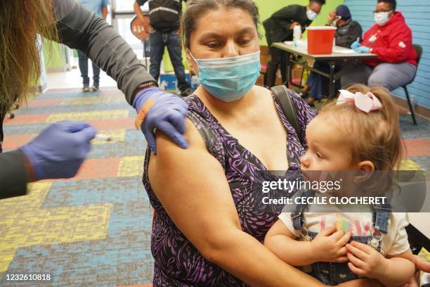 Healthcare vaccinates a woman with the Covid-19 vaccine on April 30 as the Pasadena Public Library hosts a mobile vaccine clinic set up by the Harris...