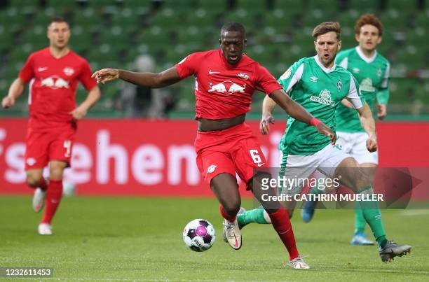 Leipzig's French defender Ibrahima Konate and Bremen's German forward Niclas Fuellkrug vie for the ball during the German Cup semi-final football...