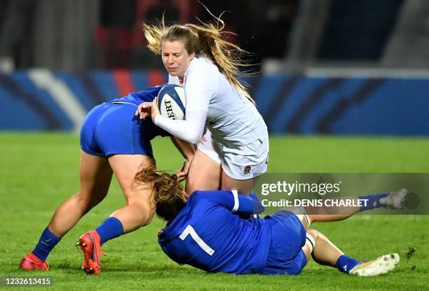 England's centre Zoe Harrison is tackled by France's flanker Gaelle Hermet during the Women's Rugby Union Test match between France and England, at...