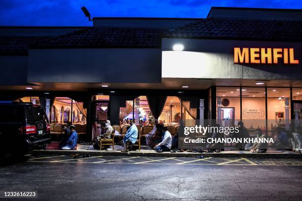 Muslim men offer prayers on the pavement outside a restaurant during the Muslim holy month of Ramadan in Lauderhill, on April 30, 2021. - Muslims...