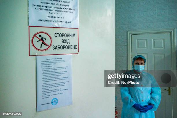 Health worker waits for a patient before the administration of AstraZeneca vaccines for priority staff in a hospital in Kyiv during the COVID-19...