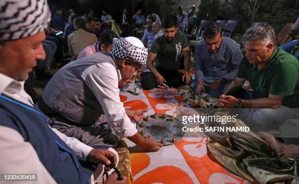 Iraqi Kurds play games after the sunset iftar during the holy Muslim month of Ramadan in Arbil, the capital of the autonomous Kurdish region of...