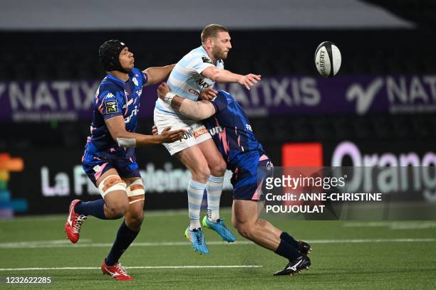 Racing 92's Scottish fly-half Finn Russell is tackled during the French Top14 rugby union match between Racing 92 and Stade Francais at La Defense...
