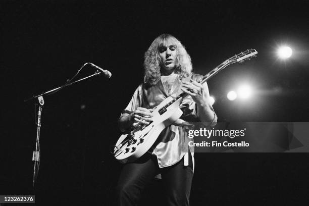 Alex Lifeson, guitarist with Canadian rock band Rush, playing the guitar during a live concert performance by the band at the Gaumont, in...