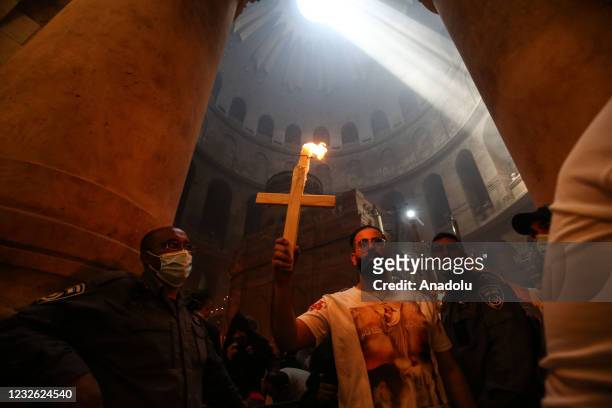 Orthodox Christians mark Holy Saturday which is a day before the Easter day at the Church of the Holy Sepulchre in East Jerusalem on May 1, 2021.