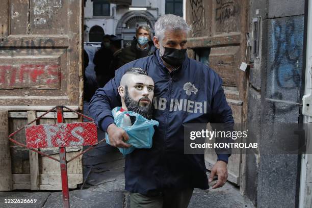 Police officer removes the bust containing the ashes of the 'baby boss' Emanuele Sibillo, killed in a Camorra ambush, from the votive chapel in the...