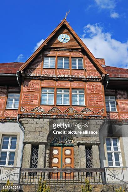 April 2021, Saxony-Anhalt, Schierke: The historic town hall was built in 1926 with a half-timbered top with elaborate colourful carvings. The...