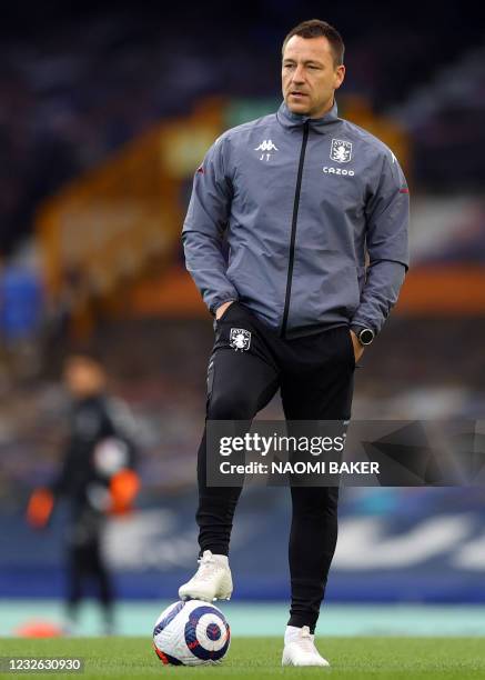 Aston Villa's English assistant coach John Terry watches the players warm up during the English Premier League football match between Everton and...