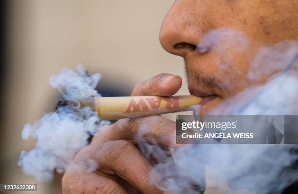 An activist smokes marijuana during the annual NYC Cannabis Parade & Rally in support of the legalization of marijuana for recreational and medical...