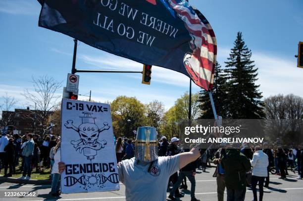 Demonstrators march against new Covid-19 anti-mask and anti-curfew restrictions, in Montreal on May 1, 2021. - The new restrictions issues by the...