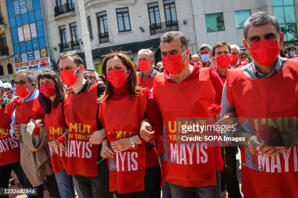 Demonstrators hold carnations during the May Day celebration at Taksim Square. The police, who wanted to prevent a demonstration on May 1, which was...