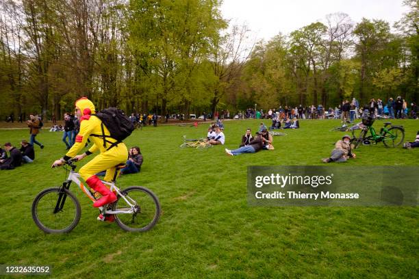Man dressed as 'La Denrée' an actor from culte movie 'La Soupe aux choux' rides his bike during the second edition of the unauthorized party 'La Boum...