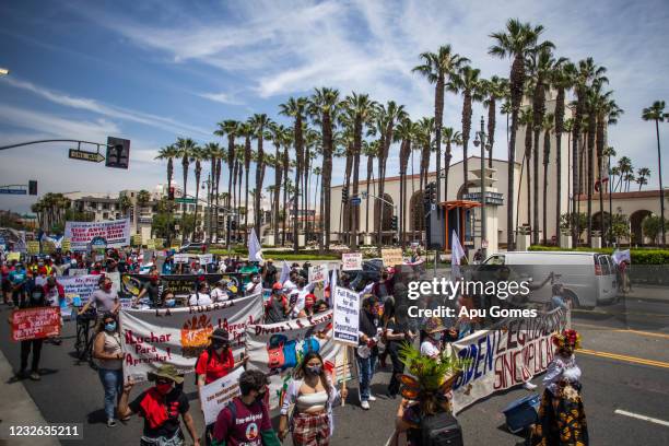 People participate in a May Day march from Chinatown to City Hall on May 1, 2021 in Los Angeles, California. May Day dates back to the height of the...