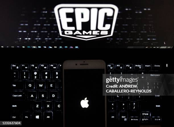 This illustration picture shows the logo from Epic Games displayed on a laptop and an Apple Logo on an iPhone in Arlington, Virginia on April 30,...