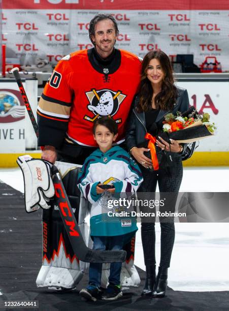 Goaltender Ryan Miller of the Anaheim Ducks poses with his wife Noureen DeWulf and son Bodhi Miller after his final career home game, a 6-2 win over...