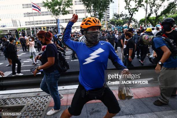 Pro-democracy protester prepares to throw a tomato during an anti-government demonstration march calling for the release of detained political...