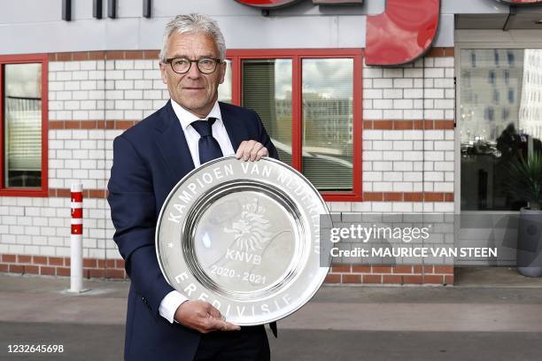 General director Eric Gudde poses with the Dutch Eredivisie trophy dish prior to the Dutch Eredivisie football match between Ajax Amsterdam and FC...