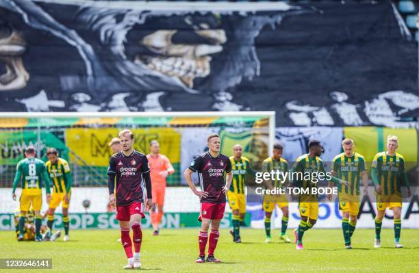 Feyenoord's Dutch midfielder Mark Diemers and Dutch midfielder Jens Toornstra stand on the pitch following their 3-1 loss during the Dutch Eredivisie...