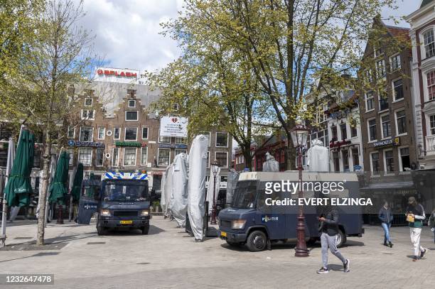 Dutch police officers stand guard the Leidseplein as Mayor Femke Halsema has issued an emergency ordinance the surrounding areas to keep the terraces...