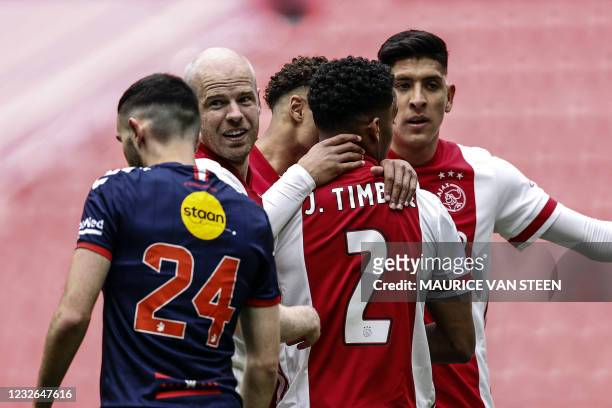Ajax's Dutch midfielder Davy Klaassen, Mexican defender Edson Alvarez and Dutch defender Jurrien Timber celebrate their 1-0 goal during the Dutch...