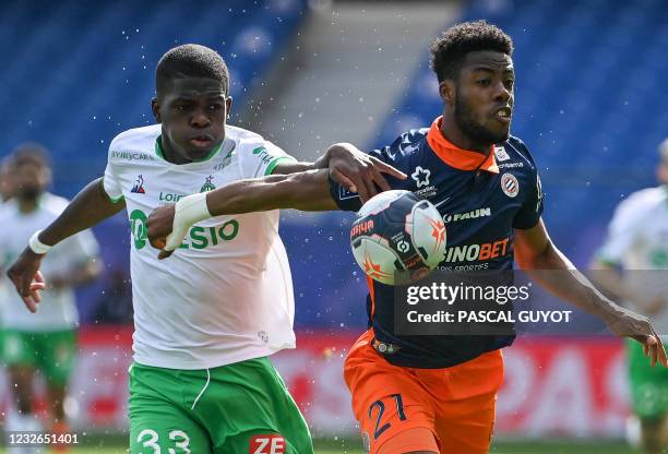 Saint-Etienne's French defender Lucas Gourna-Douath fights for the ball with Montpellier's French forward Elye Wahi during the French L1 football...