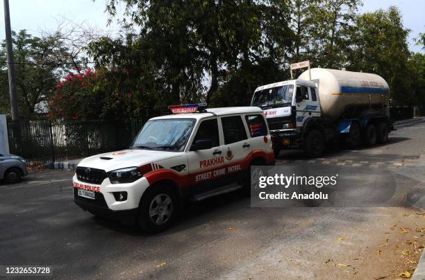 Police Control Room Van escorted a truck carrying oxygen for Covid-19 patients in New Delhi, India on May 02, 2021. Delhi police arranged for a green...