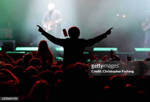 Concert-goer enjoys a non-socially distanced outdoor live music event at Sefton Park on May 2, 2021 in Liverpool, England. The event is part of the...