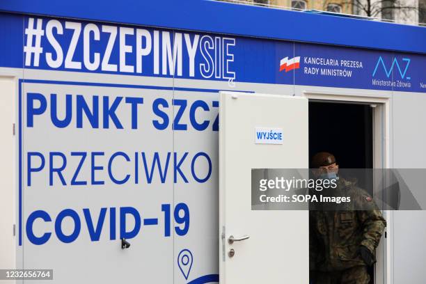 Soldier regulating the movement of patients at a vaccination centre. In March and April 2021 Poland has reached record number of daily covid-19...