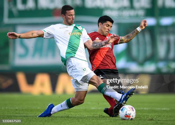 Enzo Perez of River Plate fights for the ball with Franco Quinteros of Banfield during a match between Banfield and River Plate as part of Copa de la...