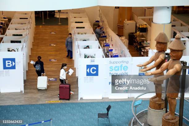 Passengers from Turkey walk to COVID-19 testing area at Vancouver International Airport in Vancouver, British Columbia, Canada on May 2021. Turkish...