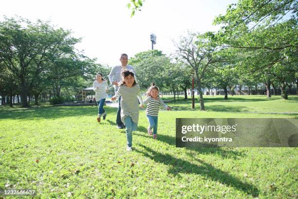 enjoy holiday with family - family in the park stock pictures, royalty-free photos & images