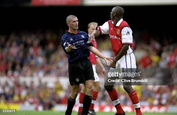 Roy Keane of Manchester United clashes with Patrick Vieira of Arsenal during the FA Carling Premiership match against Arsenal played at Highbury in...