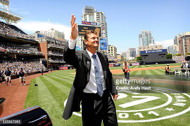 Trevor Hoffman of the San Diego Padres waves to the crowd after receiving the gift of a 1958 Cadilac convertible from Vice Chairman & Chief Executive...
