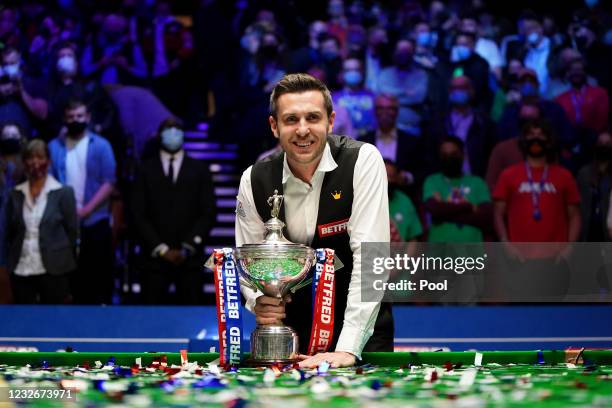Mark Selby of England celebrates with the trophy following his victory during the Final between Shaun Murphy and Mark Selby on day seventeen of the...
