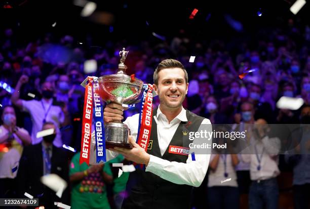 Mark Selby of England celebrates with the trophy following his victory during the Final between Shaun Murphy and Mark Selby on day seventeen of the...