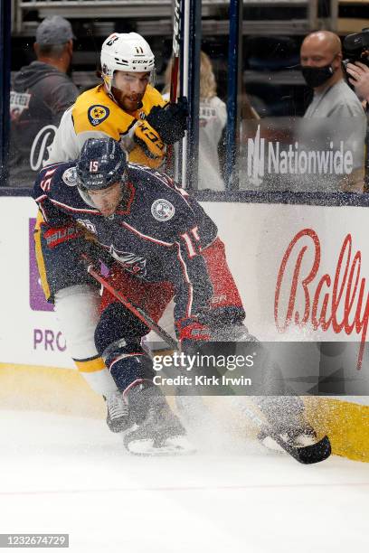 Michael Del Zotto of the Columbus Blue Jackets and Luke Kunin of the Nashville Predators chase after the puck during the first period of the game at...