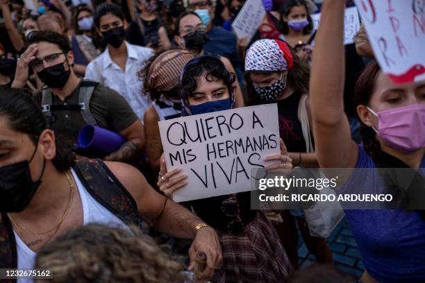 Woman member of a feminist collective holds a sign that reads in Spanish "I Want My Sisters Alive" during a demonstration against sexual violence in...