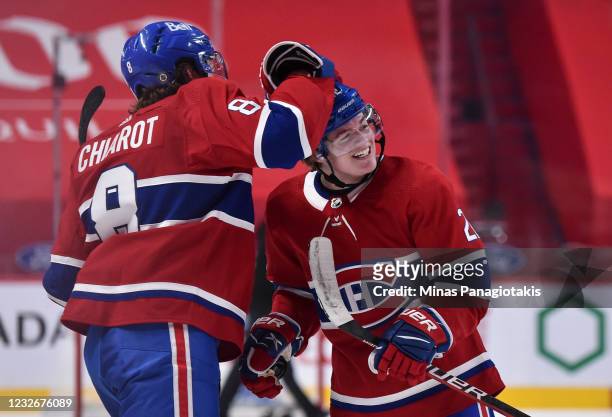 Ben Chiarot of the Montreal Canadiens congratulates Cole Caufield for his overtime game winning goal against the Toronto Maple Leafs at the Bell...
