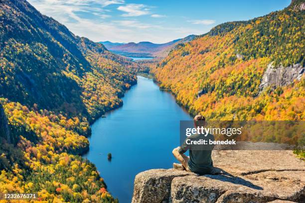man relaxing in adirondack mountains new york state usa during fall colors - new york state landscape stock pictures, royalty-free photos & images