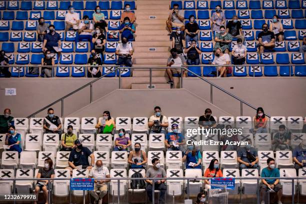 Filipinos queue to receive Russian Sputnik V COVID-19 vaccine at a sports arena on May 4, 2021 in Makati, Metro Manila, Philippines. The Philippines...