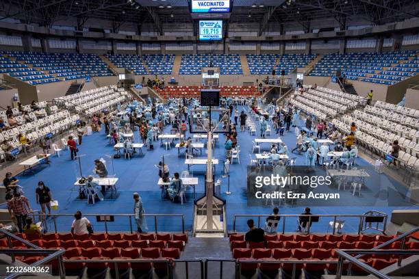 Filipinos are administered with Russian Sputnik V COVID-19 vaccine at a sports arena on May 4, 2021 in Makati, Metro Manila, Philippines. The...