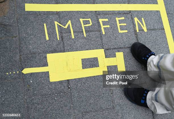 An employee of the chemical and pharmaceutical company Merck KGaA stands on the factory premises at the Covid-19 vaccination center at a floor...