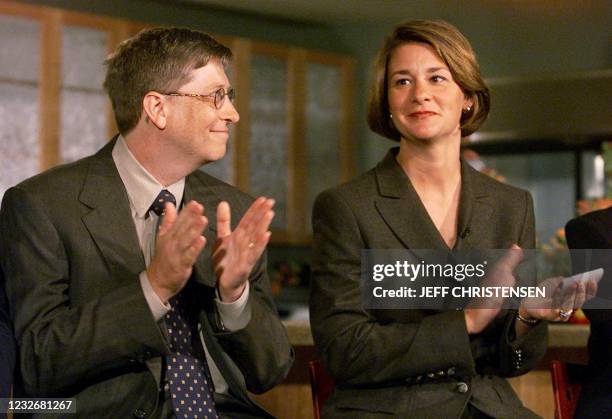 Microsoft Chairman and CEO Bill Gates looks at his wife Melinda 16 September 1999 during a press conference in Seattle where they announced the...