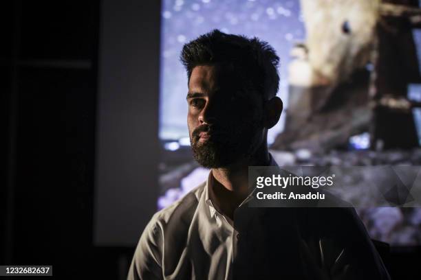 Year-old Alaaddin Halebi is seen during an interview with Anadolu Agency as he projected photos taken by him after he started to learn photography to...